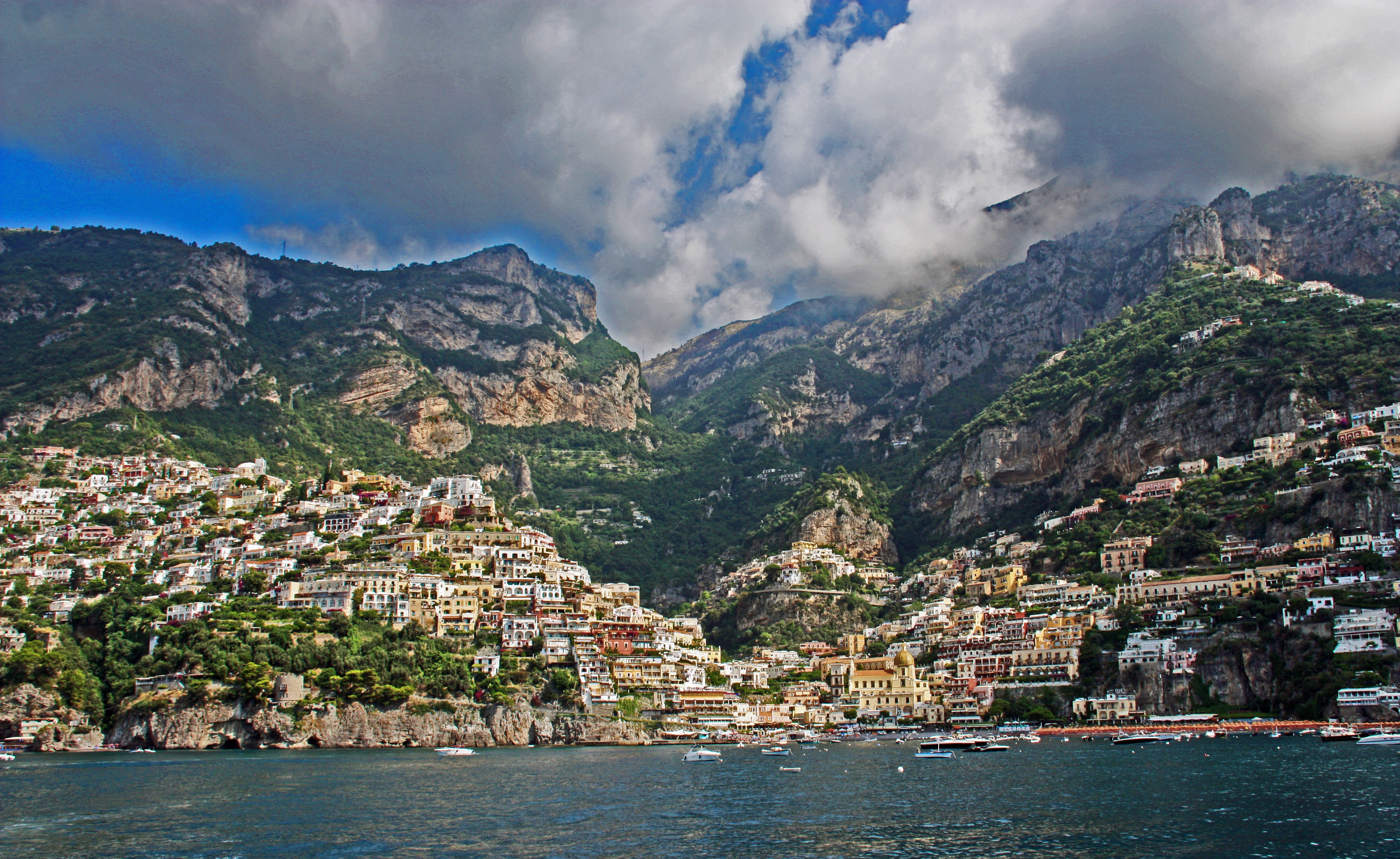 Stunning coastal view of Positano from the sea, showing the colorful buildings cascading down the cliffside