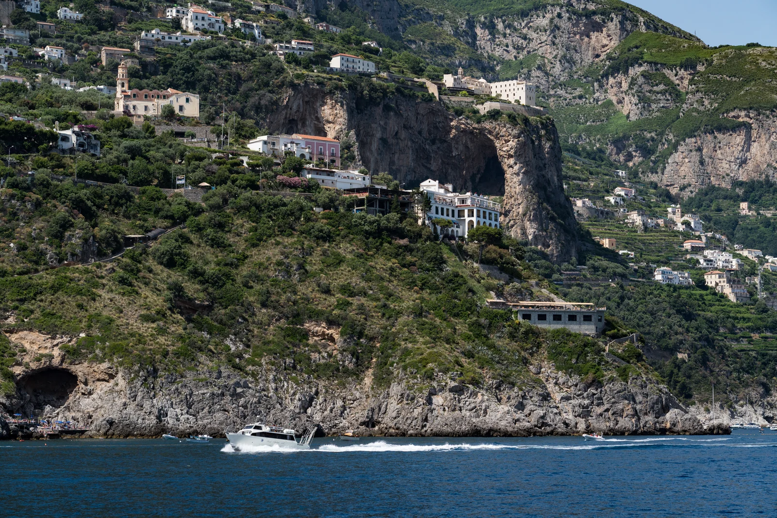 Passenger ferry cruising along the Amalfi Coast between Amalfi and Positano