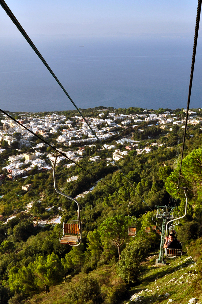 Anacapri Piazza Vittoria with local cafes and bus stop signage for budget travelers