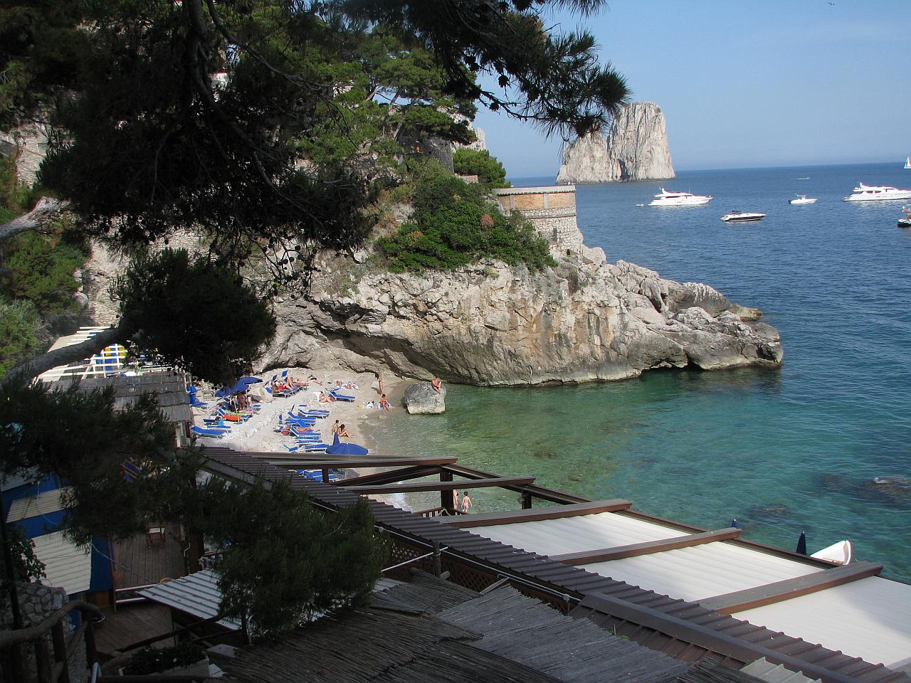 Marina Piccola free rocky beach area on Capri with swimmers and Faraglioni rocks in background