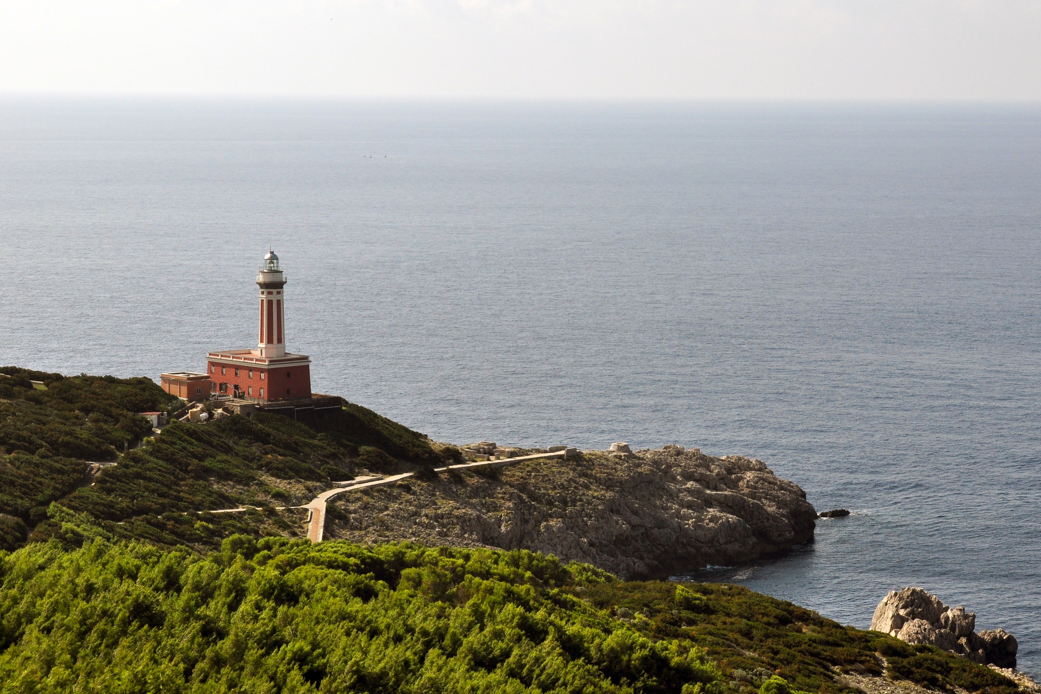Punta Carena lighthouse with rocky coastline and blue water