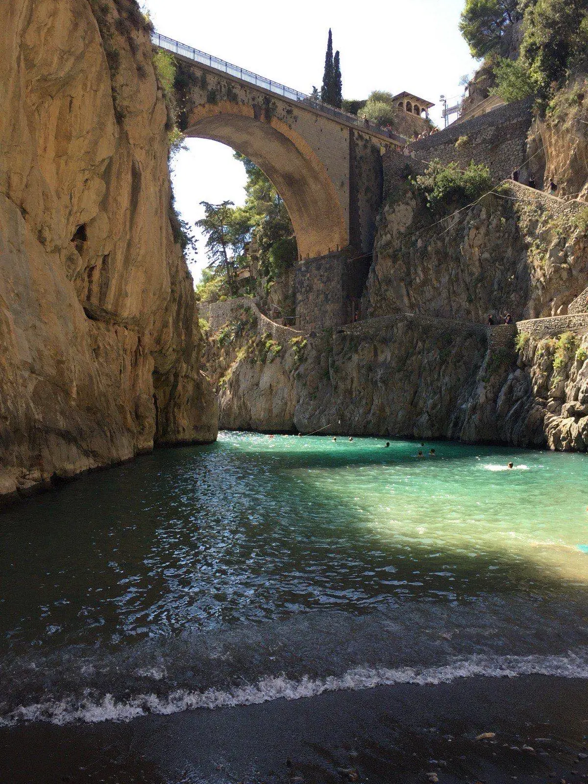 Fiordo di Furore with a bridge over a narrow inlet and turquoise water