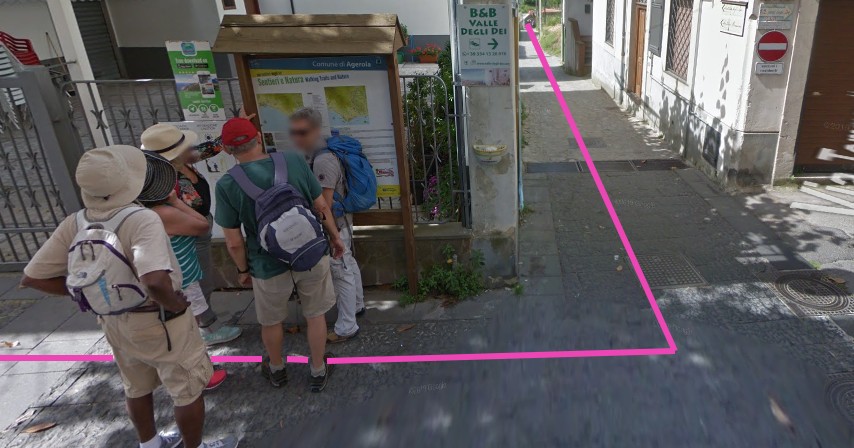 Town square (piazza) in Bomerano with left-hand route markers