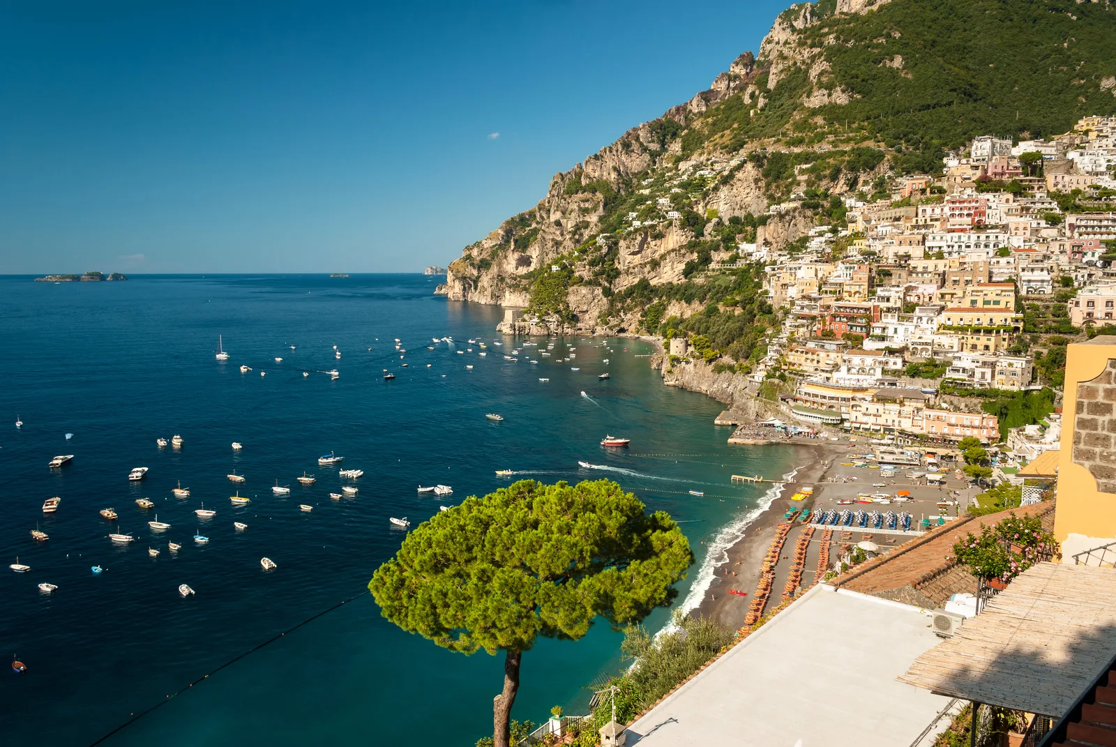Positano's main beach with colorful umbrellas and the town rising up the cliffs