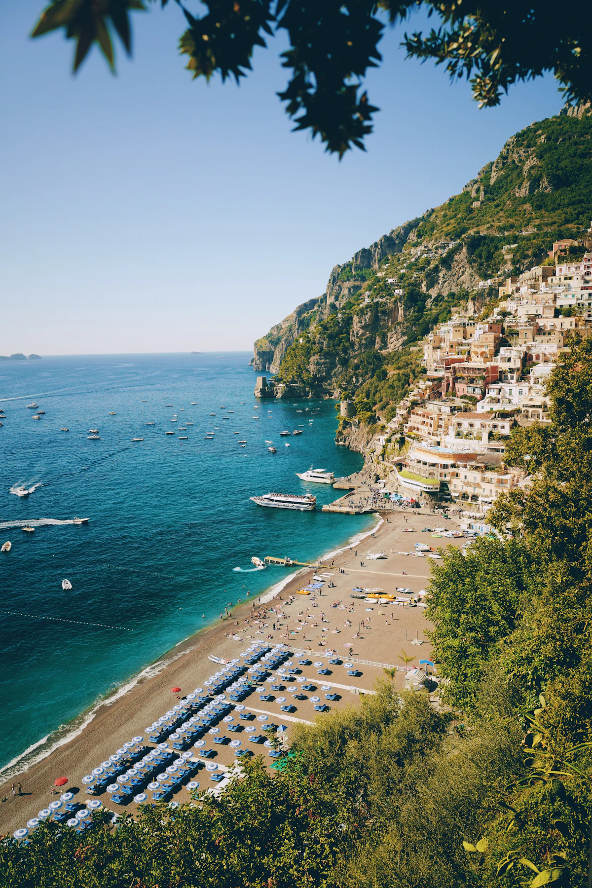 Positano beach with colourful buildings rising behind