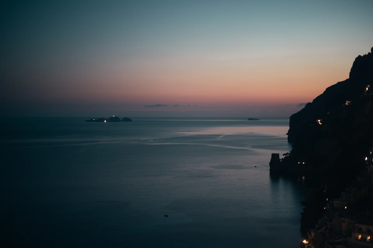Positano lit up in the evening with restaurants and cliffside lights